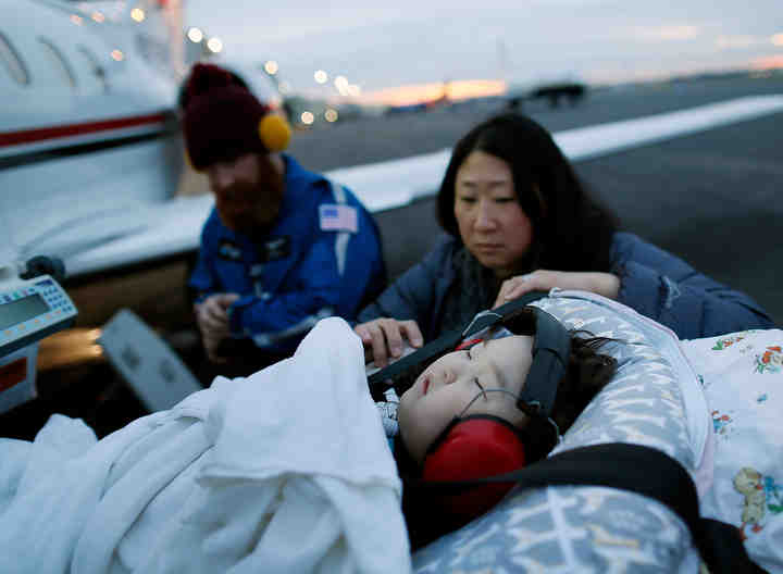 Outside the Lane Aviation hangars, Connie McKinney checks on her three-year-old son, Bryce McKinney, as he is unloaded from an ambulance and placed onto a MedFlight plane heading to Van Nuys Airport in California. Bryce has been at Nationwide Children's Hospital for the past two years receiving treatment for bronchopulmonary dysphasia. He will receive treatment at Children's Hospital Los Angeles for a few more weeks before heading home to Glendale, California.